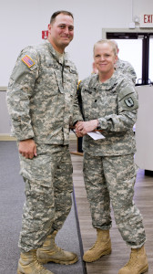 LTC Terry Barron recognizing PFC Jon Van Holm for his contributions for range safety and weapons management during the competition. (Photo by SSG Tracy J. Smith)